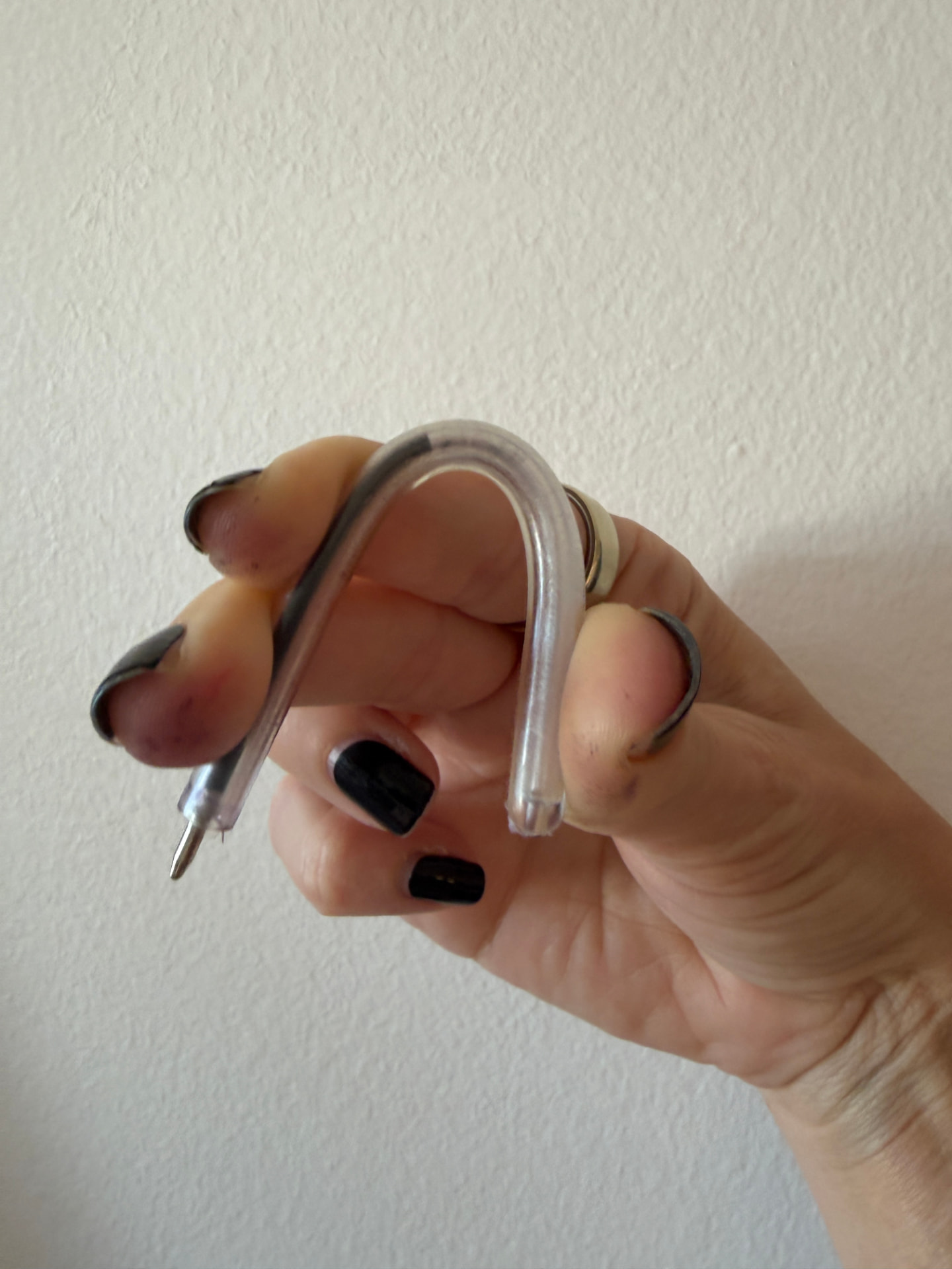 The safety pen bent almost in half between two fingers